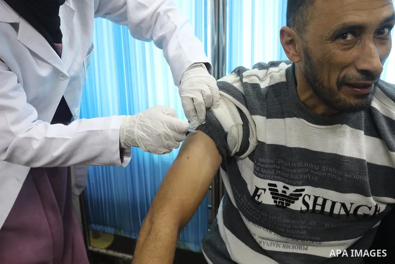 Palestinians get inoculated with a dose of the Covishield vaccine against the Covid-19 coronavirus, at a temporary vaccination centre set up, in Deir al-Balah in the center of Gaza Strip on November 211, 2021. Minister o...