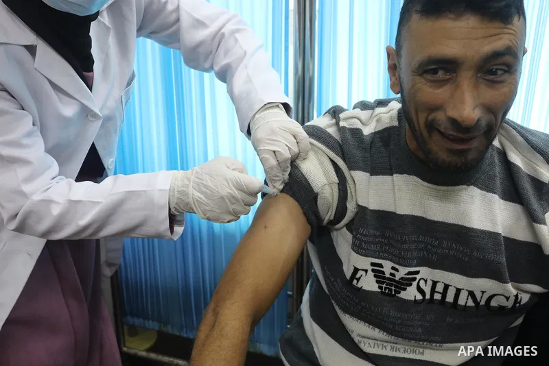 Palestinians get inoculated with a dose of the Covishield vaccine against the Covid-19 coronavirus, at a temporary vaccination centre set up, in Deir al-Balah in the center of Gaza Strip on November 211, 2021. Minister o...