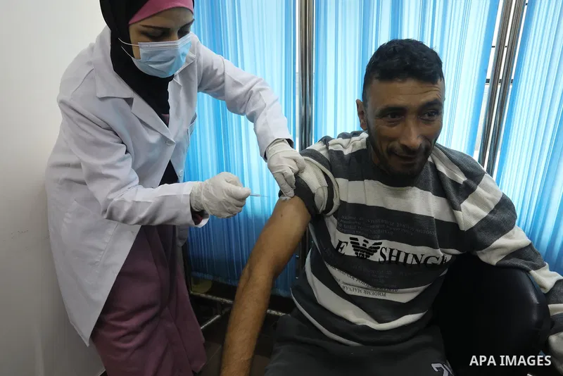 Palestinians get inoculated with a dose of the Covishield vaccine against the Covid-19 coronavirus, at a temporary vaccination centre set up, in Deir al-Balah in the center of Gaza Strip on November 211, 2021. Minister o...
