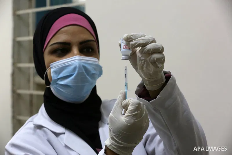 Palestinians get inoculated with a dose of the Covishield vaccine against the Covid-19 coronavirus, at a temporary vaccination centre set up, in Deir al-Balah in the center of Gaza Strip on November 211, 2021. Minister o...