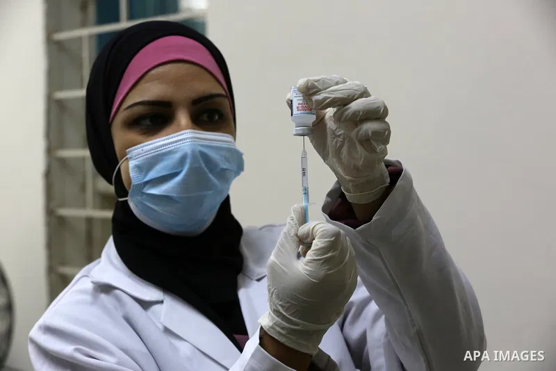 Palestinians get inoculated with a dose of the Covishield vaccine against the Covid-19 coronavirus, at a temporary vaccination centre set up, in Deir al-Balah in the center of Gaza Strip on November 211, 2021. Minister o...
