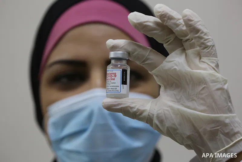 Palestinians get inoculated with a dose of the Covishield vaccine against the Covid-19 coronavirus, at a temporary vaccination centre set up, in Deir al-Balah in the center of Gaza Strip on November 211, 2021. Minister o...
