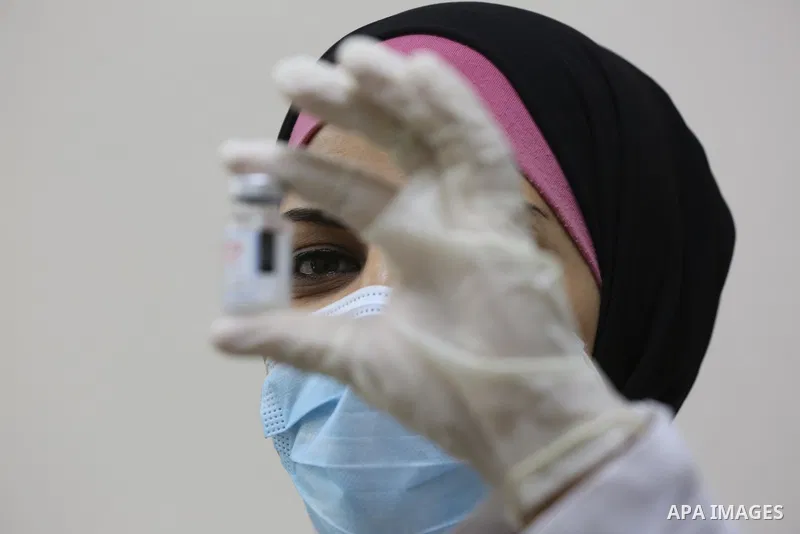 Palestinians get inoculated with a dose of the Covishield vaccine against the Covid-19 coronavirus, at a temporary vaccination centre set up, in Deir al-Balah in the center of Gaza Strip on November 211, 2021. Minister o...