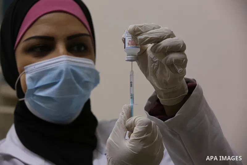 Palestinians get inoculated with a dose of the Covishield vaccine against the Covid-19 coronavirus, at a temporary vaccination centre set up, in Deir al-Balah in the center of Gaza Strip on November 211, 2021. Minister o...