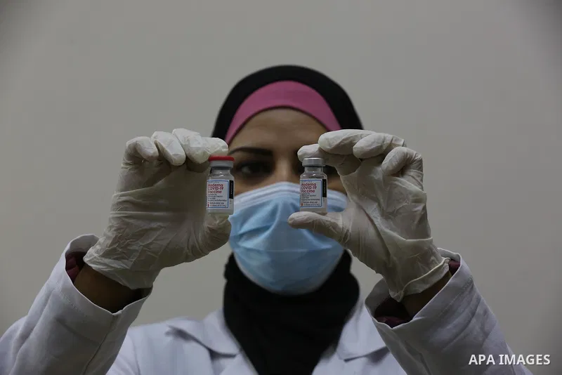 Palestinians get inoculated with a dose of the Covishield vaccine against the Covid-19 coronavirus, at a temporary vaccination centre set up, in Deir al-Balah in the center of Gaza Strip on November 211, 2021. Minister o...