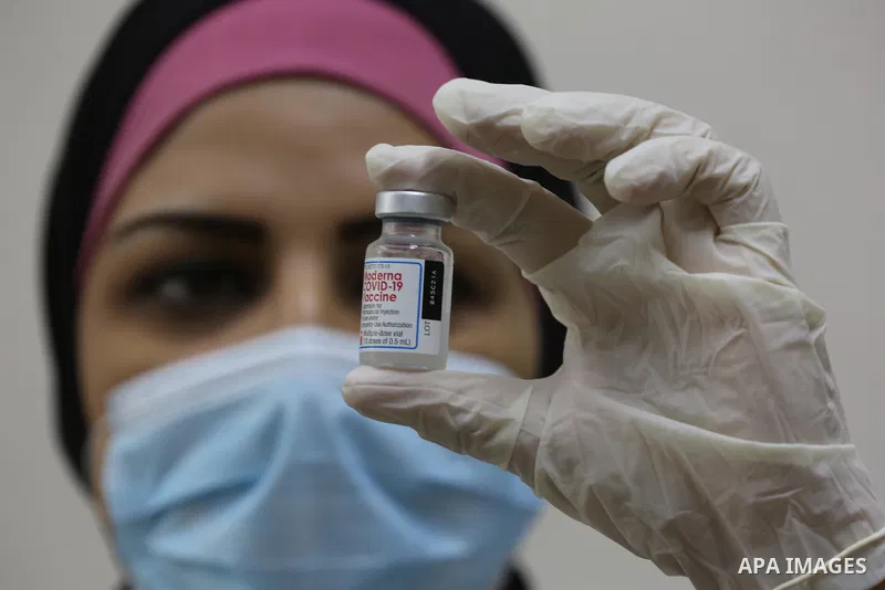 Palestinians get inoculated with a dose of the Covishield vaccine against the Covid-19 coronavirus, at a temporary vaccination centre set up, in Deir al-Balah in the center of Gaza Strip on November 211, 2021. Minister o...