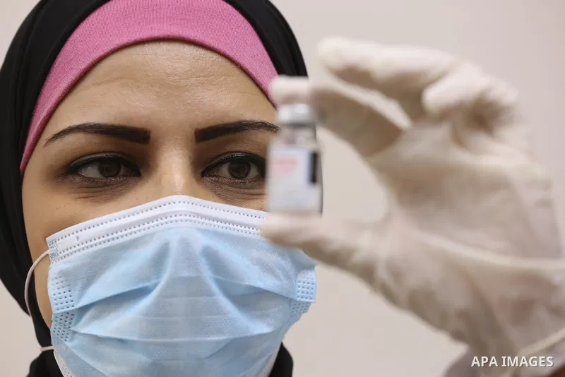 Palestinians get inoculated with a dose of the Covishield vaccine against the Covid-19 coronavirus, at a temporary vaccination centre set up, in Deir al-Balah in the center of Gaza Strip on November 211, 2021. Minister o...