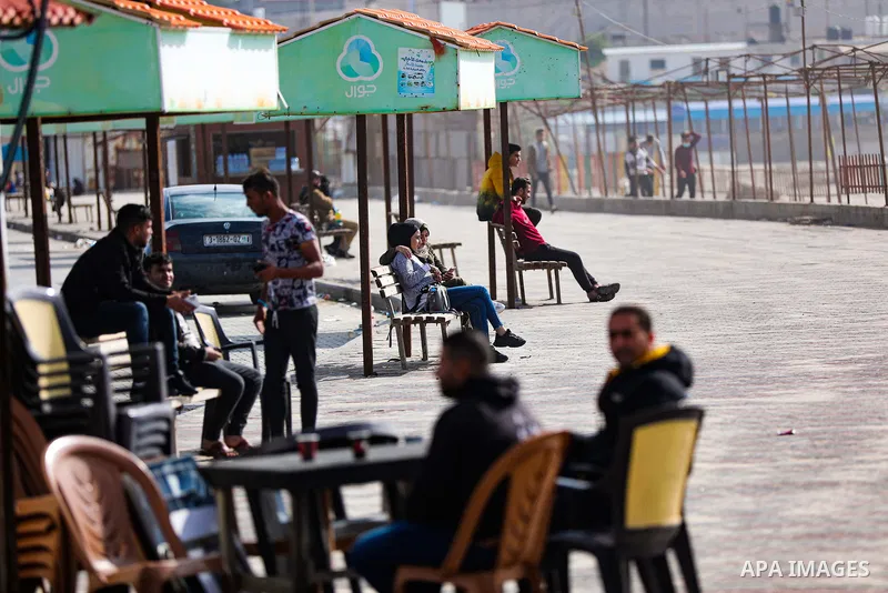 Palestians enjoy during a coldy day, at a beach in Gaza City 21 November 2021. The effects of the low pressure front which affected Palestine yesterday are expected to remain on Sunday, with a slight rise in temperature...