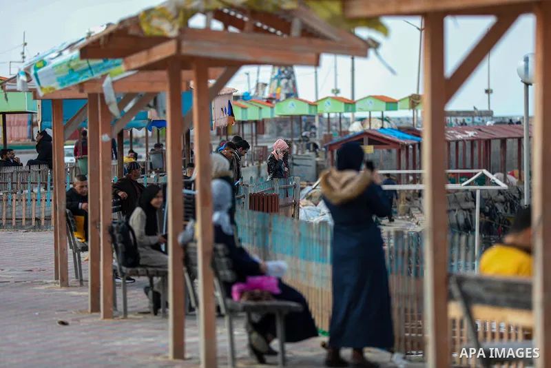 Palestians enjoy during a coldy day, at a beach in Gaza City 21 November 2021. The effects of the low pressure front which affected Palestine yesterday are expected to remain on Sunday, with a slight rise in temperature...