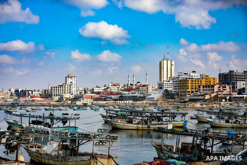 Palestians enjoy during a coldy day, at a beach in Gaza City 21 November 2021. The effects of the low pressure front which affected Palestine yesterday are expected to remain on Sunday, with a slight rise in temperature...