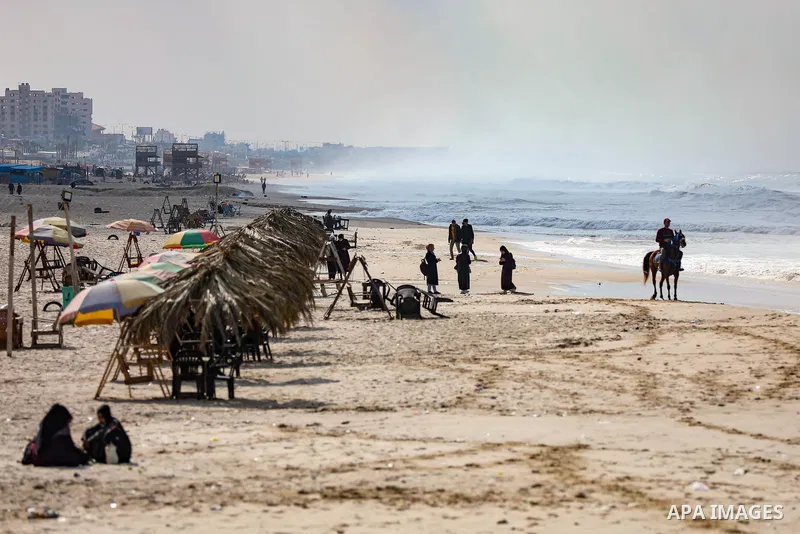 Palestians enjoy during a coldy day, at a beach in Gaza City 21 November 2021. The effects of the low pressure front which affected Palestine yesterday are expected to remain on Sunday, with a slight rise in temperature...