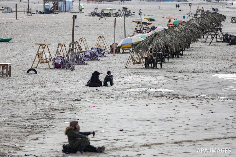 Palestians enjoy during a coldy day, at a beach in Gaza City 21 November 2021. The effects of the low pressure front which affected Palestine yesterday are expected to remain on Sunday, with a slight rise in temperature...