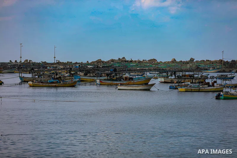 Palestians enjoy during a coldy day, at a beach in Gaza City 21 November 2021. The effects of the low pressure front which affected Palestine yesterday are expected to remain on Sunday, with a slight rise in temperature...