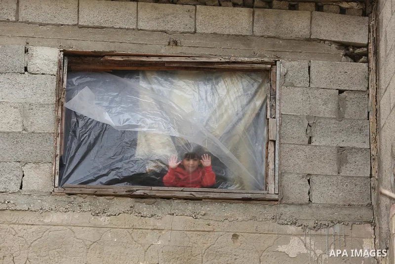 Palestinians show as they in their daily lives during a rainy day, in Deir al-Balah in the center of Gaza strip on November 21, 2021. The effects of the low pressure front which affected Palestine yesterday are expected...