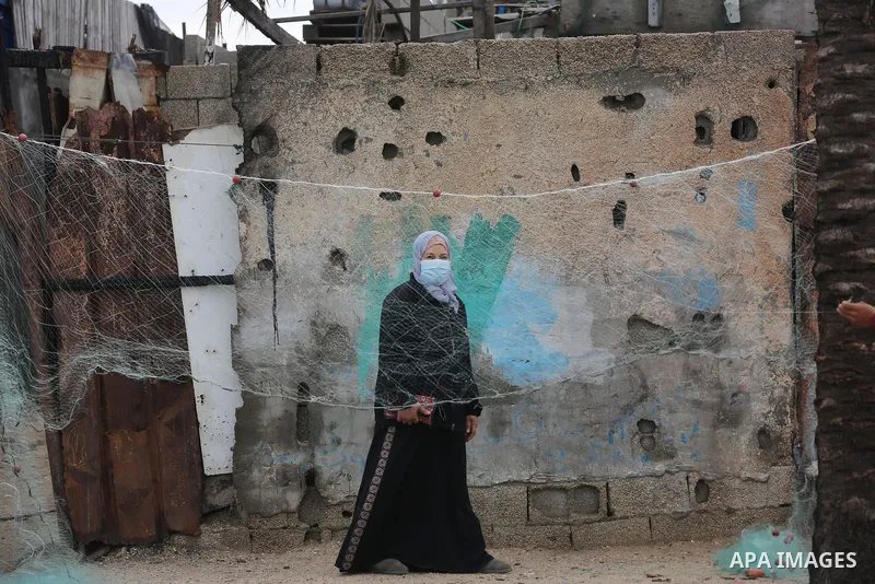 Palestinians show as they in their daily lives during a rainy day, in Deir al-Balah in the center of Gaza strip on November 21, 2021. The effects of the low pressure front which affected Palestine yesterday are expected...