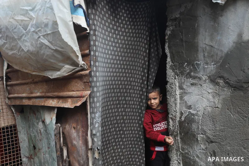 Palestinians show as they in their daily lives during a rainy day, in Deir al-Balah in the center of Gaza strip on November 21, 2021. The effects of the low pressure front which affected Palestine yesterday are expected...