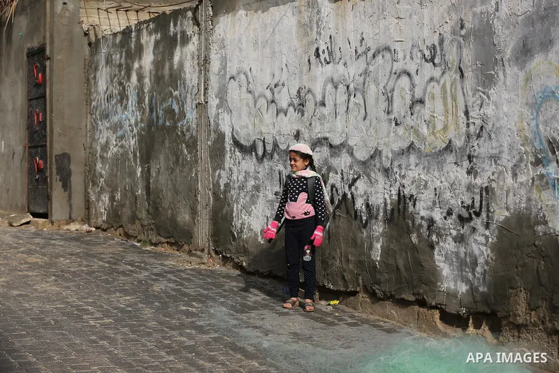 Palestinians show as they in their daily lives during a rainy day, in Deir al-Balah in the center of Gaza strip on November 21, 2021. The effects of the low pressure front which affected Palestine yesterday are expected...