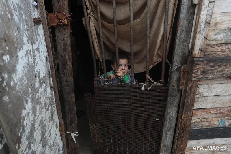 Palestinians show as they in their daily lives during a rainy day, in Deir al-Balah in the center of Gaza strip on November 21, 2021. The effects of the low pressure front which affected Palestine yesterday are expected...