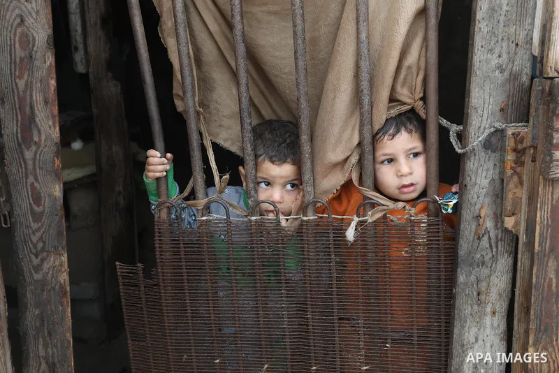 Palestinians show as they in their daily lives during a rainy day, in Deir al-Balah in the center of Gaza strip on November 21, 2021. The effects of the low pressure front which affected Palestine yesterday are expected...