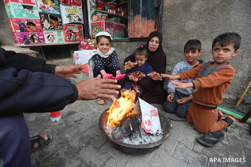 Palestinians show as they in their daily lives during a rainy day, in Deir al-Balah in the center of Gaza strip on November 21, 2021. The effects of the low pressure front which affected Palestine yesterday are expected...