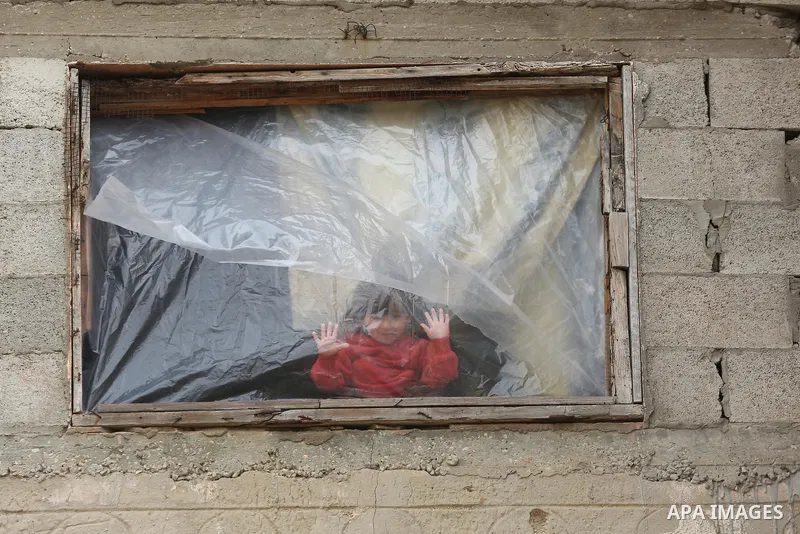 Palestinians show as they in their daily lives during a rainy day, in Deir al-Balah in the center of Gaza strip on November 21, 2021. The effects of the low pressure front which affected Palestine yesterday are expected...