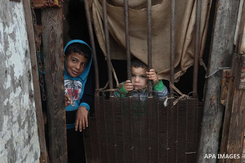 Palestinians show as they in their daily lives during a rainy day, in Deir al-Balah in the center of Gaza strip on November 21, 2021. The effects of the low pressure front which affected Palestine yesterday are expected...