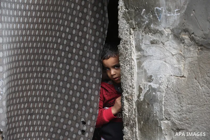 Palestinians show as they in their daily lives during a rainy day, in Deir al-Balah in the center of Gaza strip on November 21, 2021. The effects of the low pressure front which affected Palestine yesterday are expected...