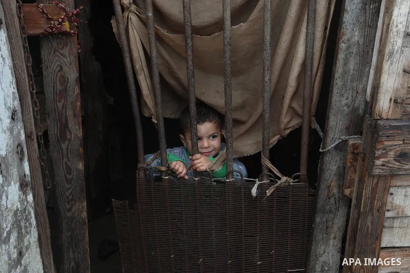 Palestinians show as they in their daily lives during a rainy day, in Deir al-Balah in the center of Gaza strip on November 21, 2021. The effects of the low pressure front which affected Palestine yesterday are expected...