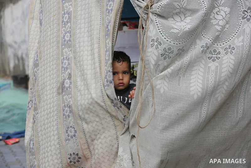 Palestinians show as they in their daily lives during a rainy day, in Deir al-Balah in the center of Gaza strip on November 21, 2021. The effects of the low pressure front which affected Palestine yesterday are expected...