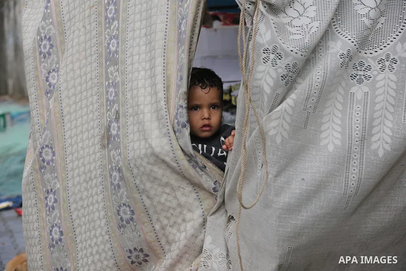 Palestinians show as they in their daily lives during a rainy day, in Deir al-Balah in the center of Gaza strip on November 21, 2021. The effects of the low pressure front which affected Palestine yesterday are expected...