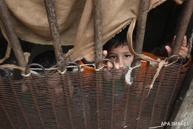 Palestinians show as they in their daily lives during a rainy day, in Deir al-Balah in the center of Gaza strip on November 21, 2021. The effects of the low pressure front which affected Palestine yesterday are expected...