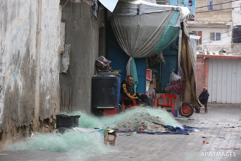 Palestinians show as they in their daily lives during a rainy day, in Deir al-Balah in the center of Gaza strip on November 21, 2021. The effects of the low pressure front which affected Palestine yesterday are expected...
