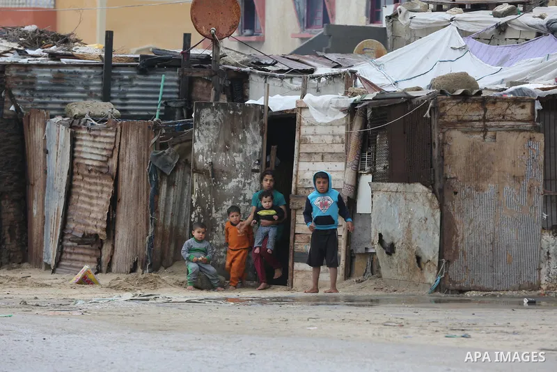 Palestinians show as they in their daily lives during a rainy day, in Deir al-Balah in the center of Gaza strip on November 21, 2021. The effects of the low pressure front which affected Palestine yesterday are expected...