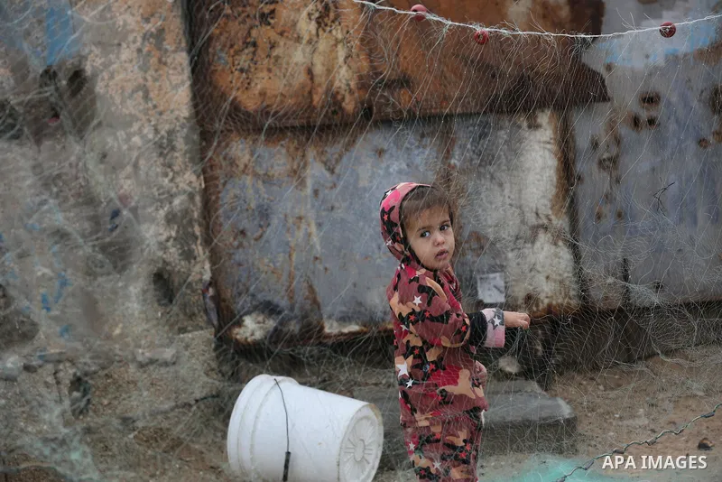 Palestinians show as they in their daily lives during a rainy day, in Deir al-Balah in the center of Gaza strip on November 21, 2021. The effects of the low pressure front which affected Palestine yesterday are expected...