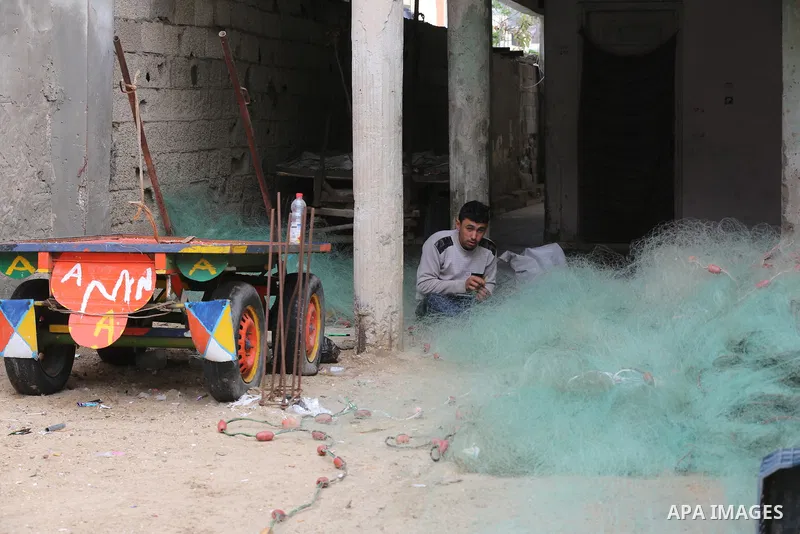 Palestinians show as they in their daily lives during a rainy day, in Deir al-Balah in the center of Gaza strip on November 21, 2021. The effects of the low pressure front which affected Palestine yesterday are expected...