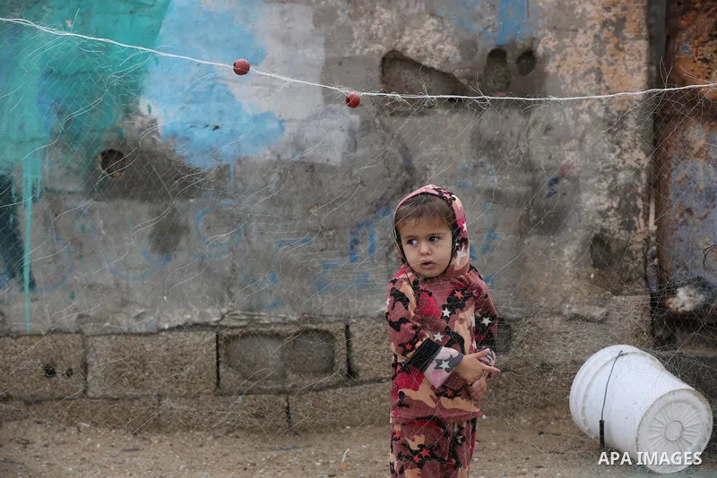 Palestinians show as they in their daily lives during a rainy day, in Deir al-Balah in the center of Gaza strip on November 21, 2021. The effects of the low pressure front which affected Palestine yesterday are expected...