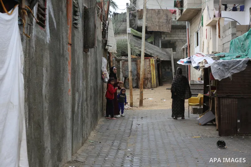 Palestinians show as they in their daily lives during a rainy day, in Deir al-Balah in the center of Gaza strip on November 21, 2021. The effects of the low pressure front which affected Palestine yesterday are expected...