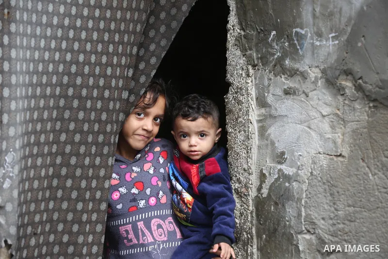 Palestinians show as they in their daily lives during a rainy day, in Deir al-Balah in the center of Gaza strip on November 21, 2021. The effects of the low pressure front which affected Palestine yesterday are expected...
