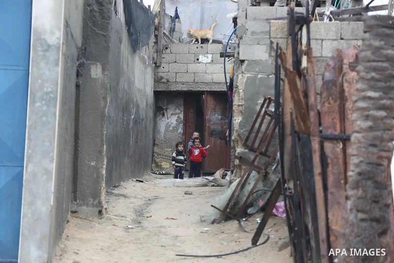 Palestinians show as they in their daily lives during a rainy day, in Deir al-Balah in the center of Gaza strip on November 21, 2021. The effects of the low pressure front which affected Palestine yesterday are expected...
