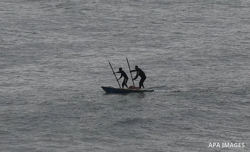 Palestinians show as they in their daily lives during a rainy day, in Deir al-Balah in the center of Gaza strip on November 21, 2021. The effects of the low pressure front which affected Palestine yesterday are expected...