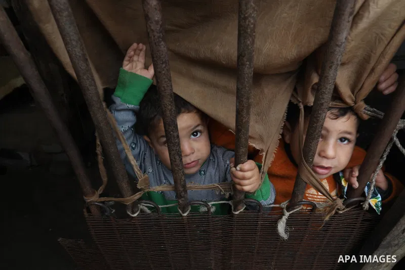 Palestinians show as they in their daily lives during a rainy day, in Deir al-Balah in the center of Gaza strip on November 21, 2021. The effects of the low pressure front which affected Palestine yesterday are expected...