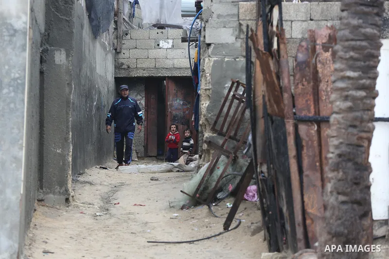 Palestinians show as they in their daily lives during a rainy day, in Deir al-Balah in the center of Gaza strip on November 21, 2021. The effects of the low pressure front which affected Palestine yesterday are expected...