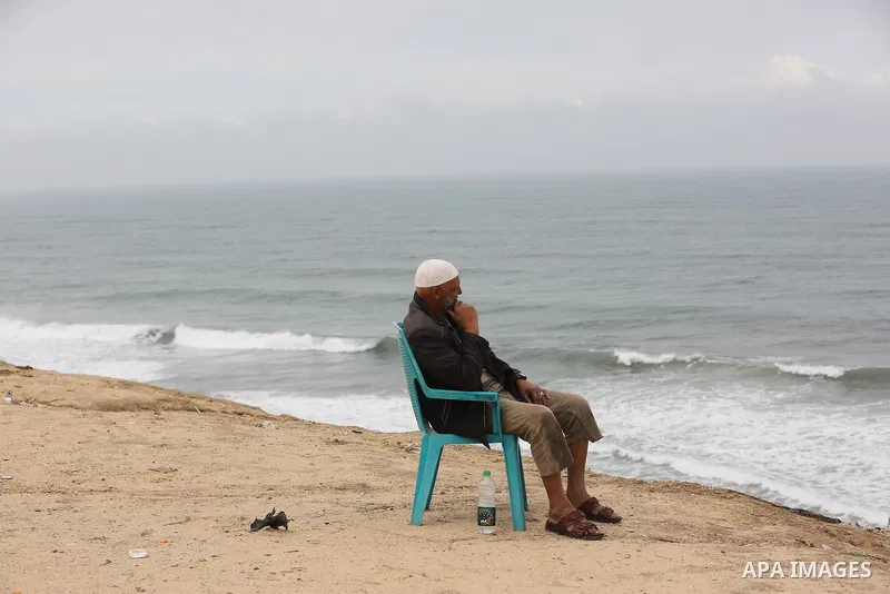 Palestinians show as they in their daily lives during a rainy day, in Deir al-Balah in the center of Gaza strip on November 21, 2021. The effects of the low pressure front which affected Palestine yesterday are expected...