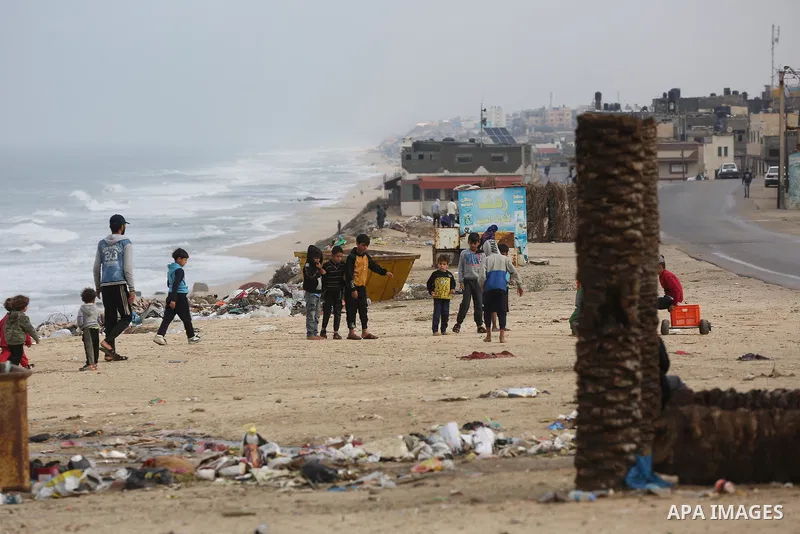Palestinians show as they in their daily lives during a rainy day, in Deir al-Balah in the center of Gaza strip on November 21, 2021. The effects of the low pressure front which affected Palestine yesterday are expected...