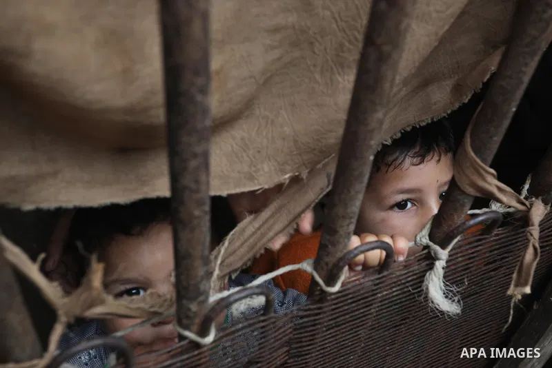 Palestinians show as they in their daily lives during a rainy day, in Deir al-Balah in the center of Gaza strip on November 21, 2021. The effects of the low pressure front which affected Palestine yesterday are expected...
