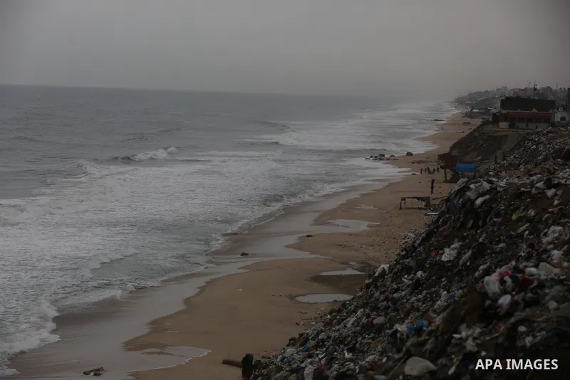 Palestinians show as they in their daily lives during a rainy day, in Deir al-Balah in the center of Gaza strip on November 21, 2021. The effects of the low pressure front which affected Palestine yesterday are expected...