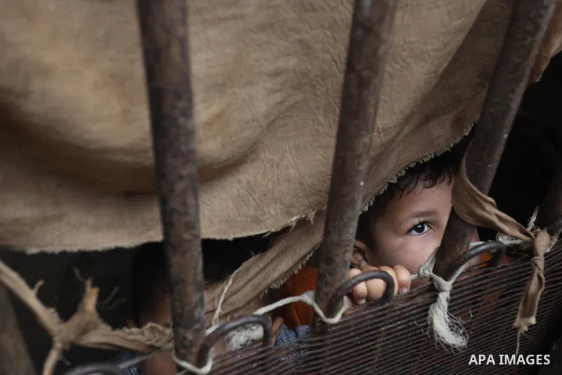 Palestinians show as they in their daily lives during a rainy day, in Deir al-Balah in the center of Gaza strip on November 21, 2021. The effects of the low pressure front which affected Palestine yesterday are expected...