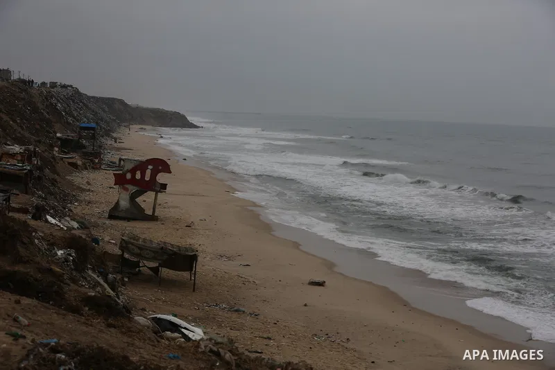 Palestinians show as they in their daily lives during a rainy day, in Deir al-Balah in the center of Gaza strip on November 21, 2021. The effects of the low pressure front which affected Palestine yesterday are expected...