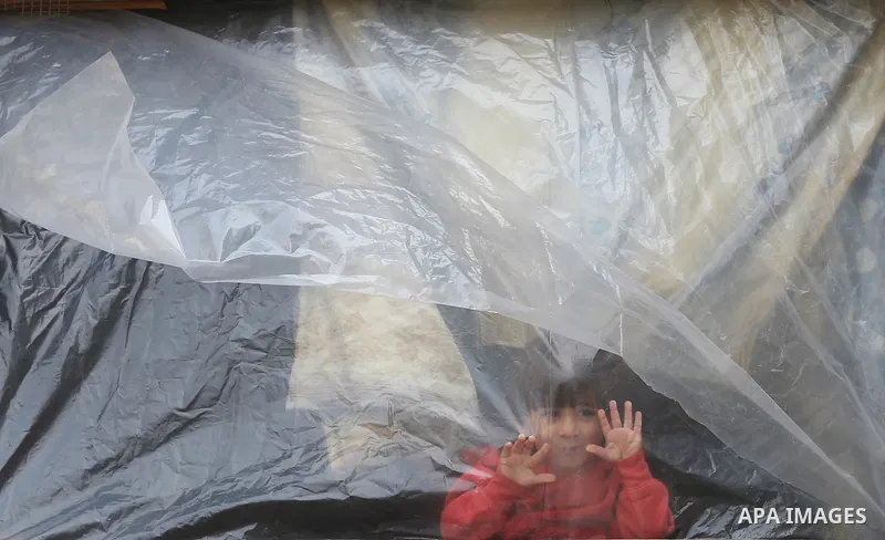 Palestinians show as they in their daily lives during a rainy day, in Deir al-Balah in the center of Gaza strip on November 21, 2021. The effects of the low pressure front which affected Palestine yesterday are expected...