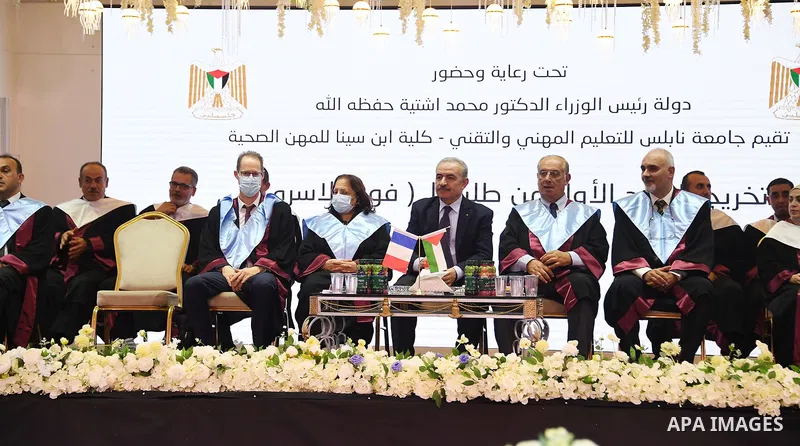 Palestinian Prime Minister Mohammed Ishtayeh participates in the graduation ceremony of the first cohort of Nablus University for Vocational and Technical Education, in the West Bank city of Ramallah, on November 21, 202...